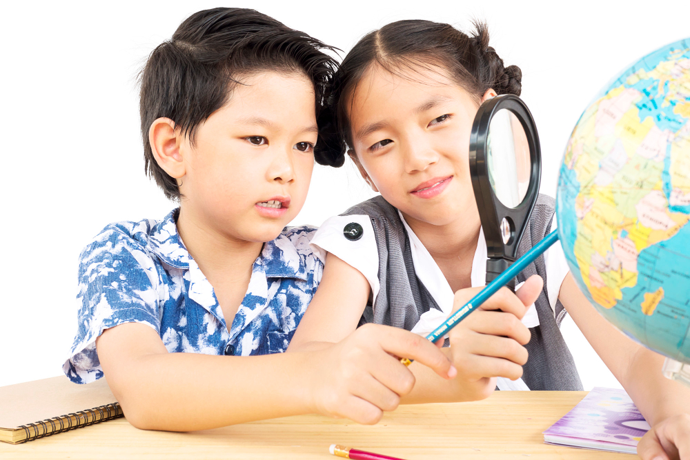 asian-kids-are-studying-globe-using-magnifier-white-background-2022-09-30.jpg