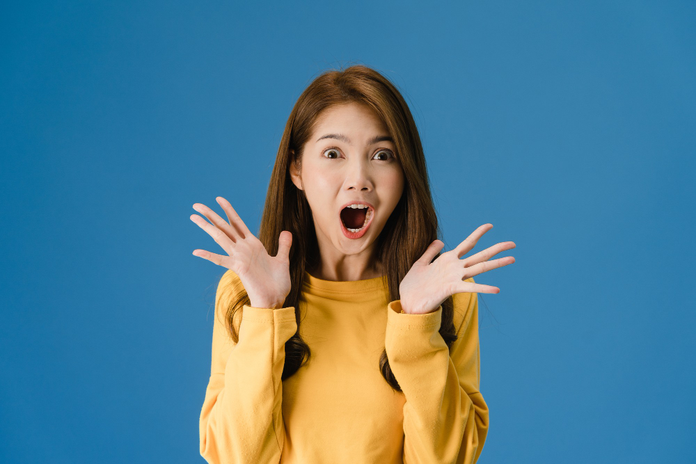 young-asia-lady-feeling-happiness-with-positive-expression-joyful-surprise-funky-dressed-casual-cloth-looking-camera-isolated-blue-background-happy-adorable-glad-woman-rejoices-success-2022-09-30.jpg